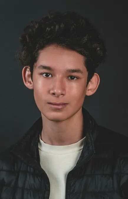 A former pupil, now a teenager, in a dark jacket